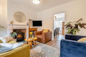 a living room with two couches and a fireplace at Little Hamilton - Wimborne in Wimborne Minster