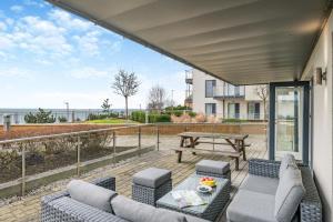 a patio with a table and chairs and a picnic table at Bournemouth Bay View in Bournemouth