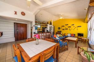 a dining room and living room with a table and chairs at Yool Caanal Unit 5 in Akumal