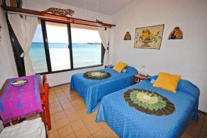 a bedroom with two beds and a view of the ocean at Yool Caanal Unit 5 in Akumal
