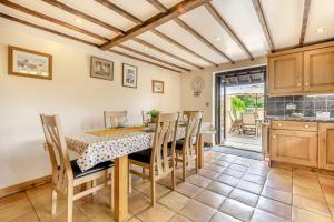 a kitchen and dining room with a table and chairs at Abbeydale in Wool