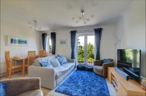 a living room with a couch and a tv at 3 The Downs in Swanage
