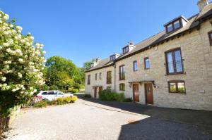 a large brick house with a car parked in the driveway at 3 The Downs in Swanage