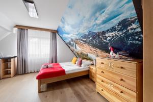 a bedroom with a mountain mural on the wall at DW Na Równi Białka Tatrzańska in Białka Tatrzanska +57 photos