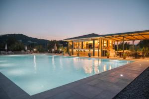 a large swimming pool in front of a building at La Hacienda in Ulcinj