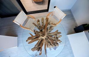 a glass table with two chairs on top of it at Ares Suites 3 in Plataria