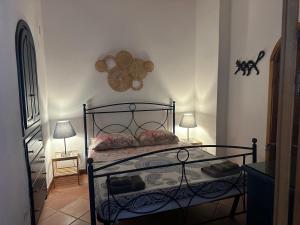 a bedroom with a bed with a wrought iron frame at Schicciolina in Stromboli