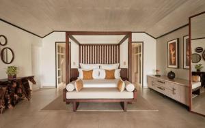 a bedroom with a large bed with a wooden headboard at Carlisle Bay in Old Road