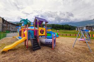 a childrens playground with a slide and a play equipment at Bakuriani Crystal Loft Apt in Bakuriani