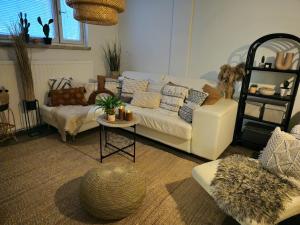a living room with a white couch and a table at 3room apartment at central Jyväskylä in Jyväskylä