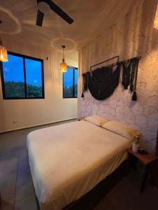 Ένα ή περισσότερα κρεβάτια σε δωμάτιο στο Villa curandero