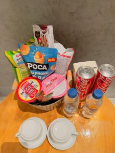 a table with a basket of food and some drinks at Trốn House in An Bình (1)