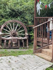 an old woodenoked wheel sitting next to a fence at Willow Lodge in Llancarfan