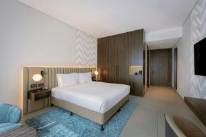 a hotel room with a bed and a couch at Courtyard by Marriott World Trade Centre, Dubai in Dubai