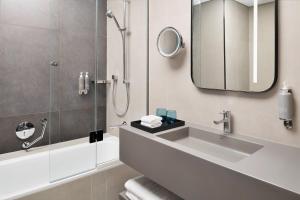 a bathroom with a sink and a mirror at Courtyard by Marriott World Trade Centre, Dubai in Dubai