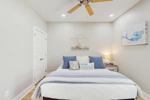 a bedroom with a bed and a ceiling fan at Oasis Retreat in Rockport +16 photos