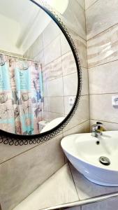 a bathroom with a sink and a mirror at Casa Angelina 2 in Laganas