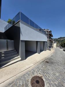 a building with a staircase on the side of a street at Douro Valley - Casa do Padrinho in Escamarão