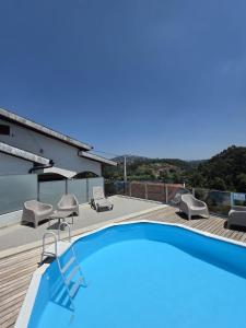 a swimming pool on the roof of a house at Douro Valley - Casa do Padrinho in Escamarão