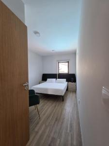 a bedroom with a white bed and a window at Douro Valley - Casa do Padrinho in Escamarão +29 photos