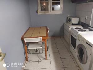a small kitchen with a table and a stove at Chambre Privée 1 BONNEUIL SUR MARNE 30 minutes from Paris in Bonneuil-sur-Marne