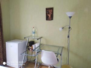 a room with a glass table and a chair and a lamp at Chambre Privée 1 BONNEUIL SUR MARNE 30 minutes from Paris in Bonneuil-sur-Marne