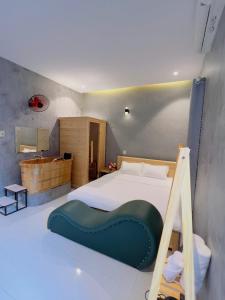 a bedroom with a bed with a green object on it at Trốn House in An Bình (1)