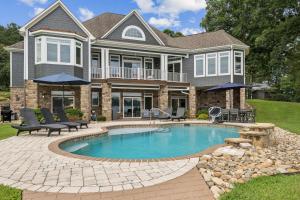 a house with a swimming pool in front of a house at Still Waters at Bankhead in Denver