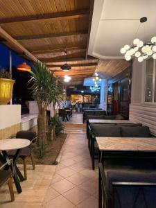 a restaurant with tables and chairs and a bar at Golden Rock Hotel in Kemer +17 photos