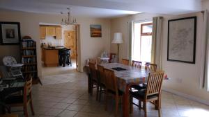 a dining room and kitchen with a table and chairs at Caitin's in Kells