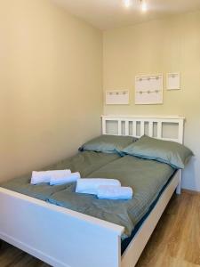a bedroom with a bed with two towels on it at Apartament 88 - Mrągowo Centrum, 2 sypialnie, taras in Mrągowo
