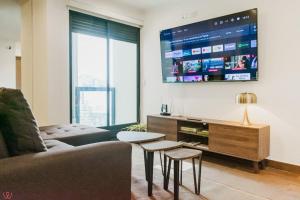 a living room with a couch and a tv at Magnificent 2BR Pool in Miraflores in Lima