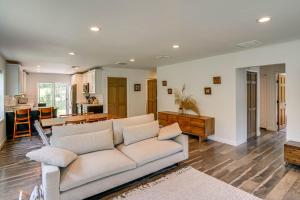 a living room with a white couch and a kitchen at Family Home with Outdoor Oasis in Hudson Valley in High Falls