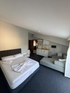 a bedroom with a large bed and a couch at Golden Rock Hotel in Kemer