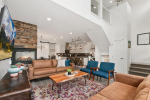 a living room with a couch and a table at The Cycle Haus Rooftop Deck with Hot Tub and Views in Fort Collins