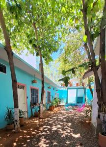 a building with trees in front of it at Flow De Lupe in Brisas de Zicatela