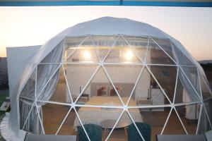 an igloo house with a table and chairs in it at Domes at the Beach in Maroni