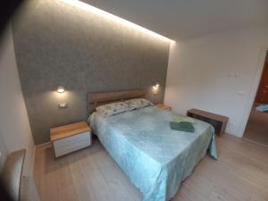 a bedroom with a bed with a blue comforter at Casa Lilly in Orsaria