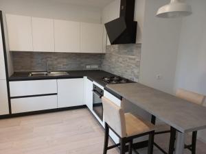 a kitchen with white cabinets and a table with chairs at Casa Lilly in Orsaria