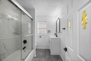 a white bathroom with a shower and a sink at Bloomfield Pittsburgh B Stylish and Cozy Private Bedroom, Shared Bathroom, with Free Parking in Pittsburgh +17 photos