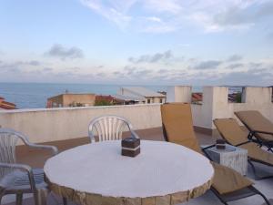 a table and chairs on a balcony with the ocean at Samaya in Eforie Nord