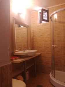 a bathroom with a sink and a shower and a toilet at Samaya in Eforie Nord