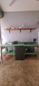 a green table in a room with a shelf at Flow De Lupe in Brisas de Zicatela +9 photos