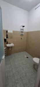 a bathroom with a toilet and a sink at Flow De Lupe in Brisas de Zicatela