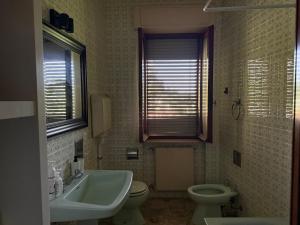 a bathroom with a sink and a toilet and a sink at Residenza Il Castello in CastellʼArquato +102 photos