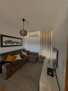 a living room with a couch and a table at Urban Oasis in Mealhada