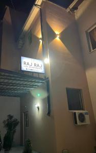a sign on the side of a building with lights at RajRaj apartmani Gradiska in Bosanska Gradiška