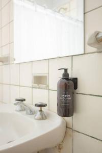a bottle of soap on a sink in a bathroom at Coliving en Junin Habitacion Sextuple en Hostel in Junín