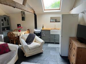 a kitchen with a white refrigerator and a table at Cosy lodge WestburyonSevern in Gloucestershire