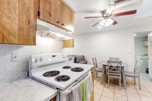 a kitchen with a white stove and a table at Garcia Getaway 2 Bed 2 Bath Small Family Pool Home in Sarasota +11 photos